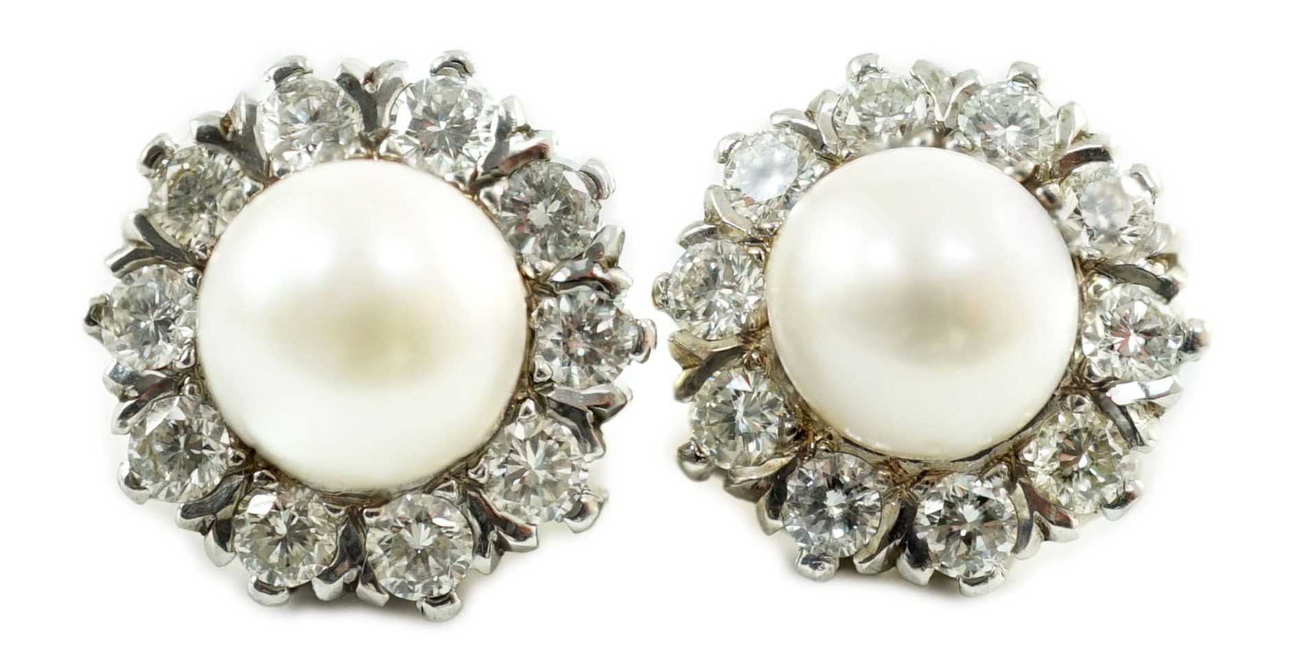 A pair of white gold? cultured pearl and diamond cluster set circular earrings